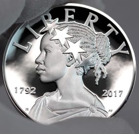 2017 Silver African American Lady Liberty Medal being held carefully by a gloved hand